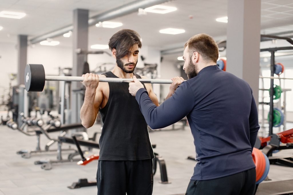 indian man doing excercisses on special equipment at gym with pe